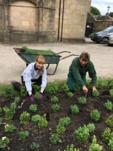 Apprentice Michelle assisting the head gardener at Whalley Abbey.